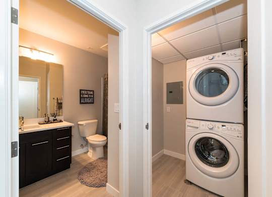 A white washer and dryer in a small laundry room.