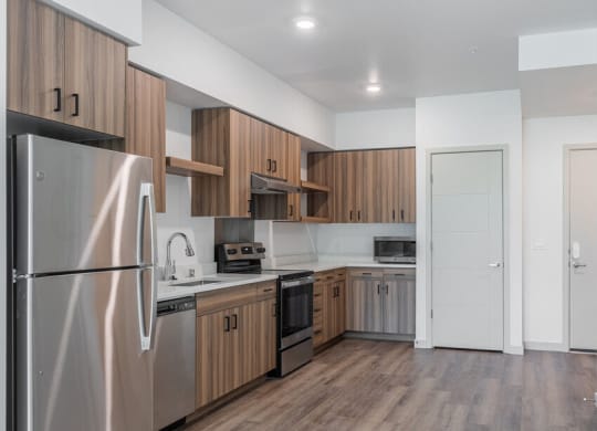a kitchen with wooden cabinets and stainless steel appliances