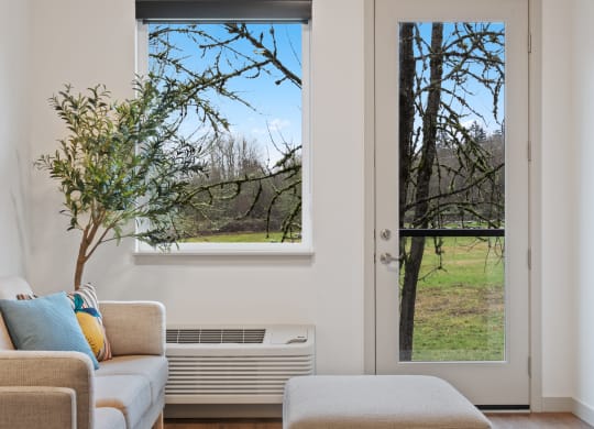 a living room with a couch and an and a window with a