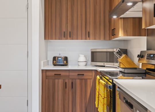 a kitchen with a stove top oven and a microwave