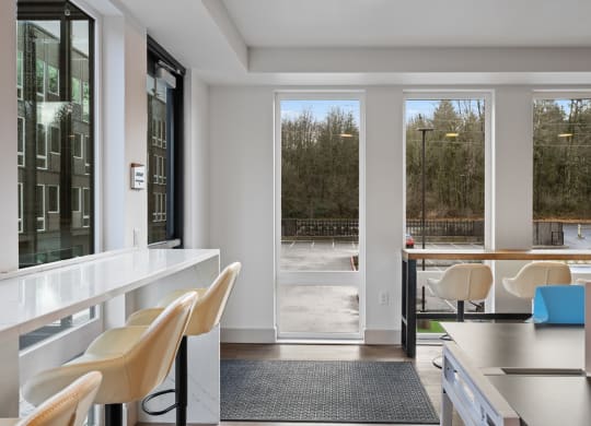 a living room with a table and chairs and sliding glass doors