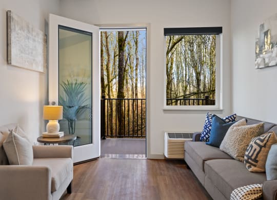 a living room with a couch and a door to a balcony
