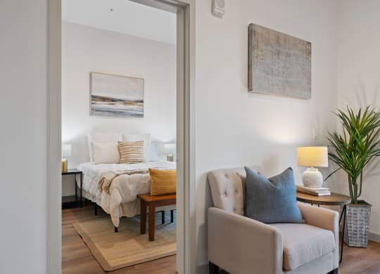 a bedroom with a large bed and a living room with a couch