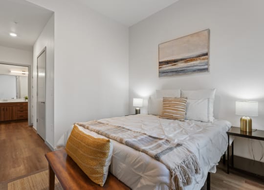 a bedroom with a large bed and a bathroom