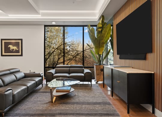 a living room with leather couches and a television