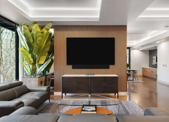 a living room with a couch and a tv on the wall