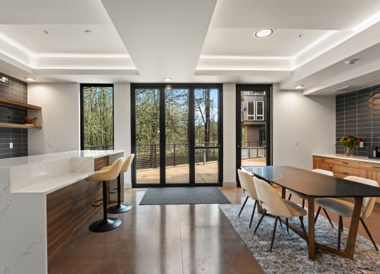 a large kitchen and dining area with a table and chairs and sliding glass doors