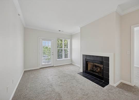 A living room with a fireplace and sliding glass doors.