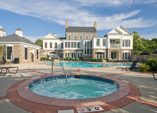 a hot tub with a fountain in front of a large house  at Harper's Crossing, Langhorne, 19047