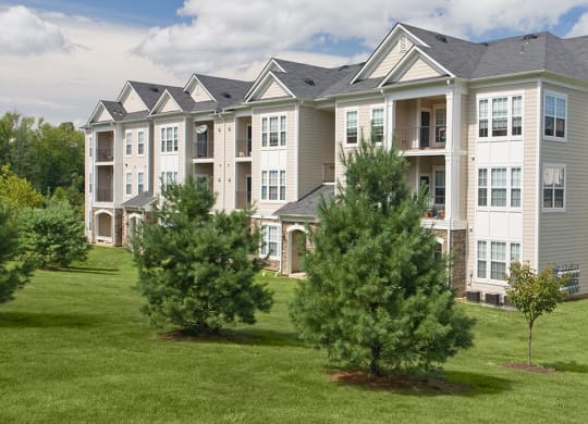a large apartment complex with trees in front of it  at Harper's Crossing, Langhorne, PA