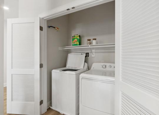 White Laundry Room with Shelves at Heritage Court, Ewing, NJ