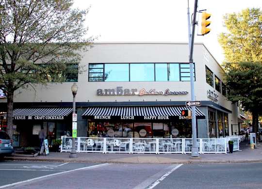 A street view of a restaurant named Ember Bar and Grill.