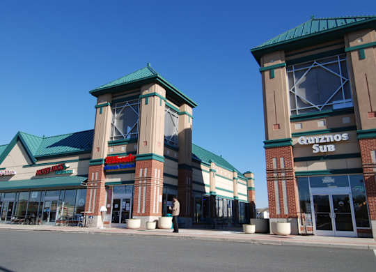 A Quiznos Sub store is located in a strip mall.