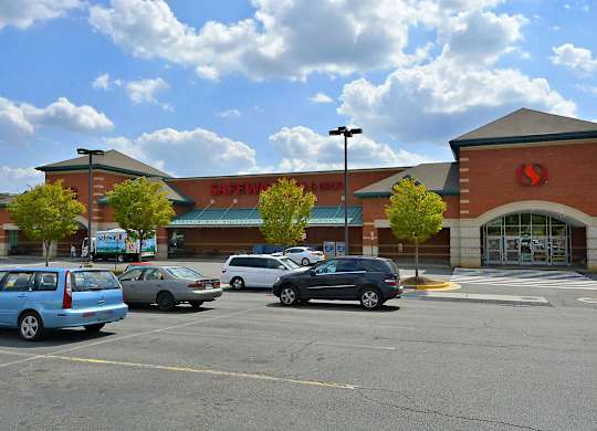 A parking lot in front of a Safeway store.