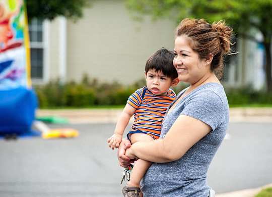 A woman holding a child in her arms.