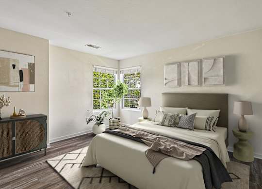 A bedroom with a large bed and a window.