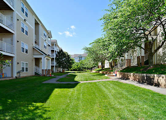 A sunny day at a grassy apartment complex.