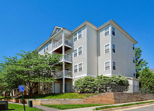 A large apartment building with a balcony on the second floor.