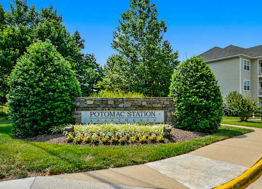 A sign that says Potomac Station in front of a building.