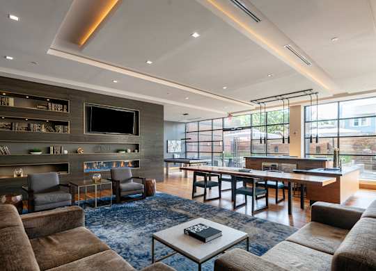 A modern living room with a fireplace and a large window.
