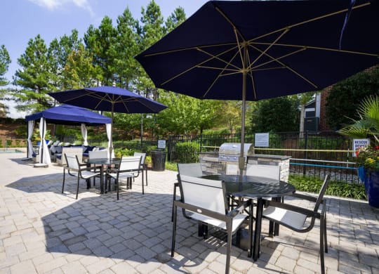 a patio with tables and umbrellas