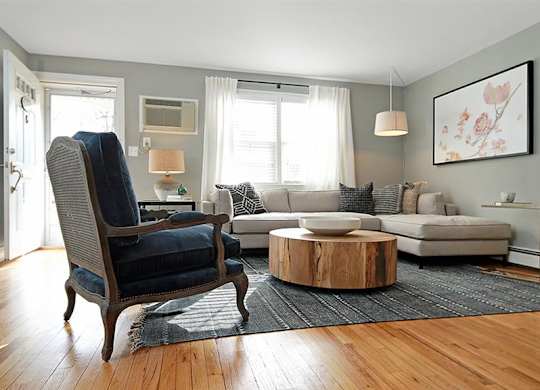 Living area featuring section sofa, round coffee table, and accent chair at Alister Morristown, Morristown, NJ, 07960