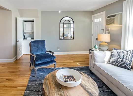 Living area opening up to kitchen area and featuring full size, stack-able washer and dryer at Alister Morristown, New Jersey