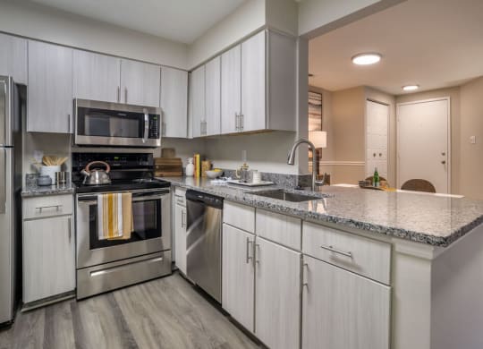 Renovated Kitchen with stainless steel appliances and granite countertops at Elme Manassas, Virginia