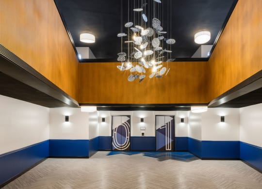 Big lobby with chandelier and two elevators at Elme Alexandria, Alexandria, 22304