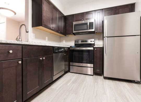 Kitchen with stainless steel appliances and granite countertops at Elme Manassas, Virginia