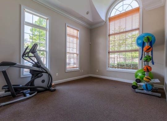 a workout room with an exercise bike and a window