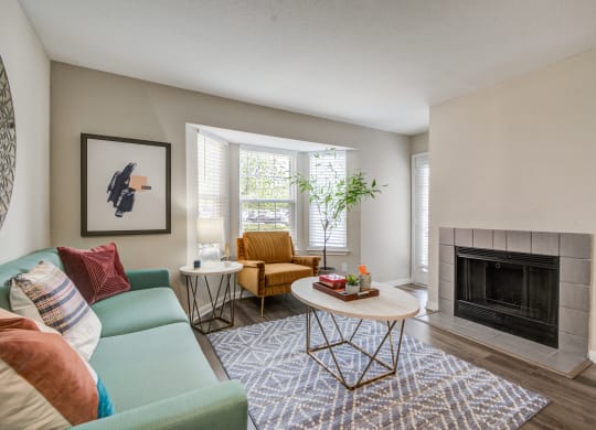 a living room with a blue couch and a coffee table at Elme Herndon, Herndon, Virginia 