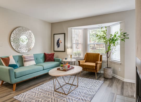 a living room with a blue couch at Elme Herndon, Herndon, Virginia and a coffee table at Elme Herndon, Herndon, VA