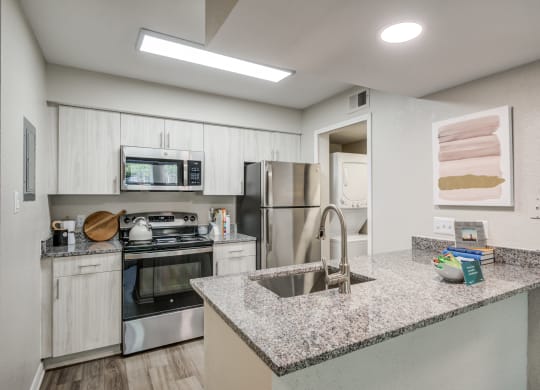 Renovated Kitchen with stainless steel appliances and granite countertops at Elme Herndon, Herndon, VA