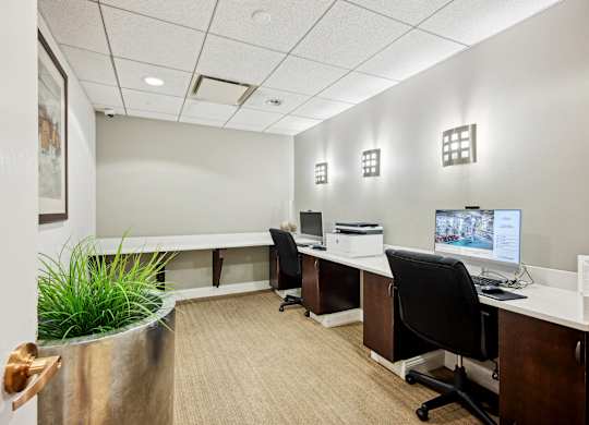 A modern office with a long desk and a computer on it.