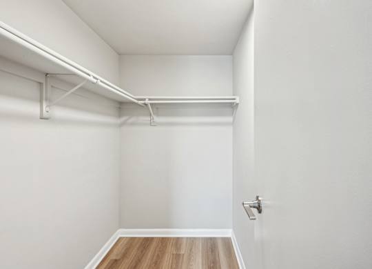 A white room with a wooden floor and a door at Cascade at Landmark, Virginia