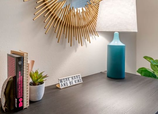 Desk with a lamp and a mirror on the wall at Elme Alexandria, Alexandria Virginia