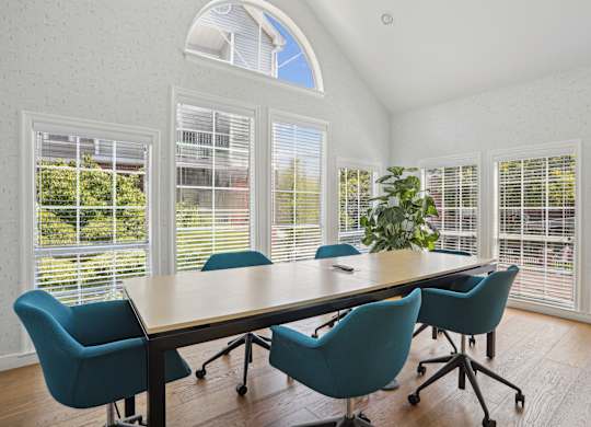 A conference room with a large table and chair at Elme Alexandria, Alexandria, 22304.