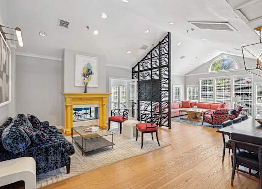 A living room with a fireplace and a dining table at Elme Alexandria, Alexandria, 22304