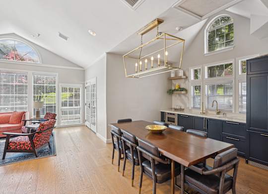 A dining room with a wooden table and chairs.