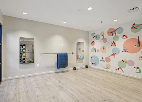 A room with a large mural of people and objects on the wall.