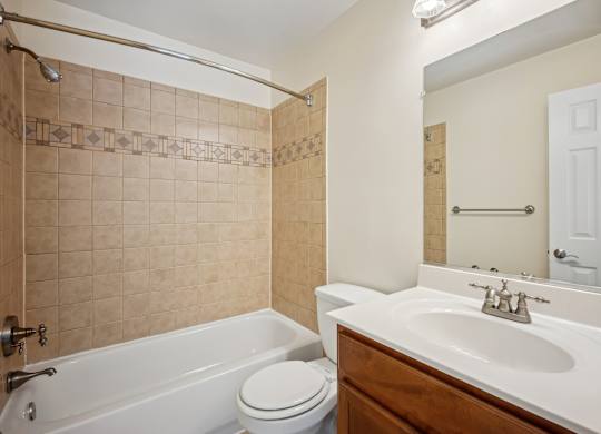 A bathroom with a white tub, toilet, and sink at Elme Bethesda, Bethesda, 20814