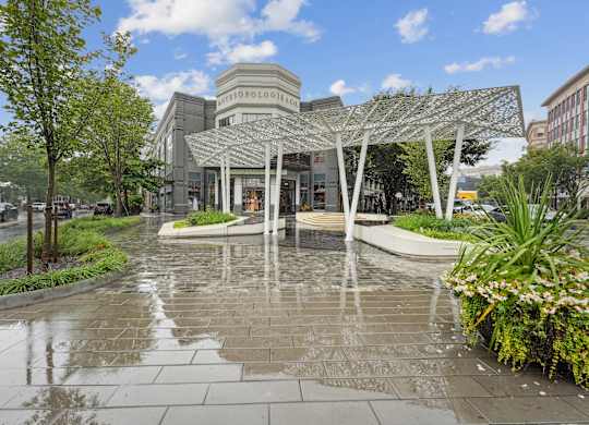 A building with a glass facade and a metal trellis structure in front at Elme Bethesda, Bethesda, 20814