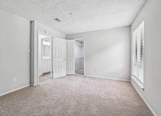 A room with a carpeted floor and white walls.