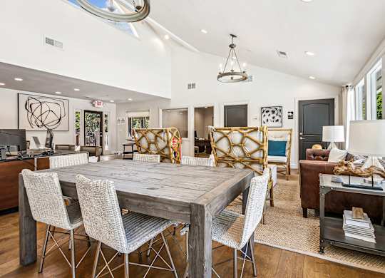A modern dining room with a wooden table and chairs.
