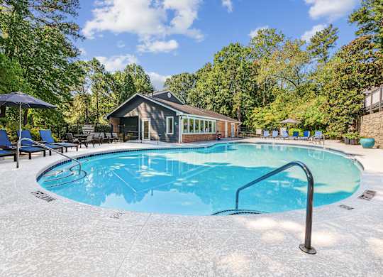 A small pool with a metal ladder in the middle of it.