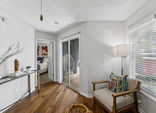 A living room with a chair and a table at Elme Druid Hills, Atlanta, Georgia