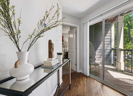 A white vase with a plant sits on a black countertop at Elme Druid Hills, Atlanta, Georgia