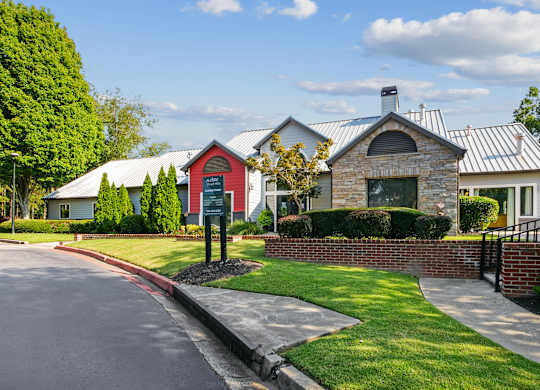 A house with a red door and a sign in front of it.