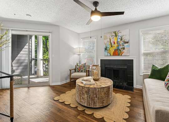 A living room with a fireplace and a painting on the wall at Elme Druid Hills, Atlanta, Georgia